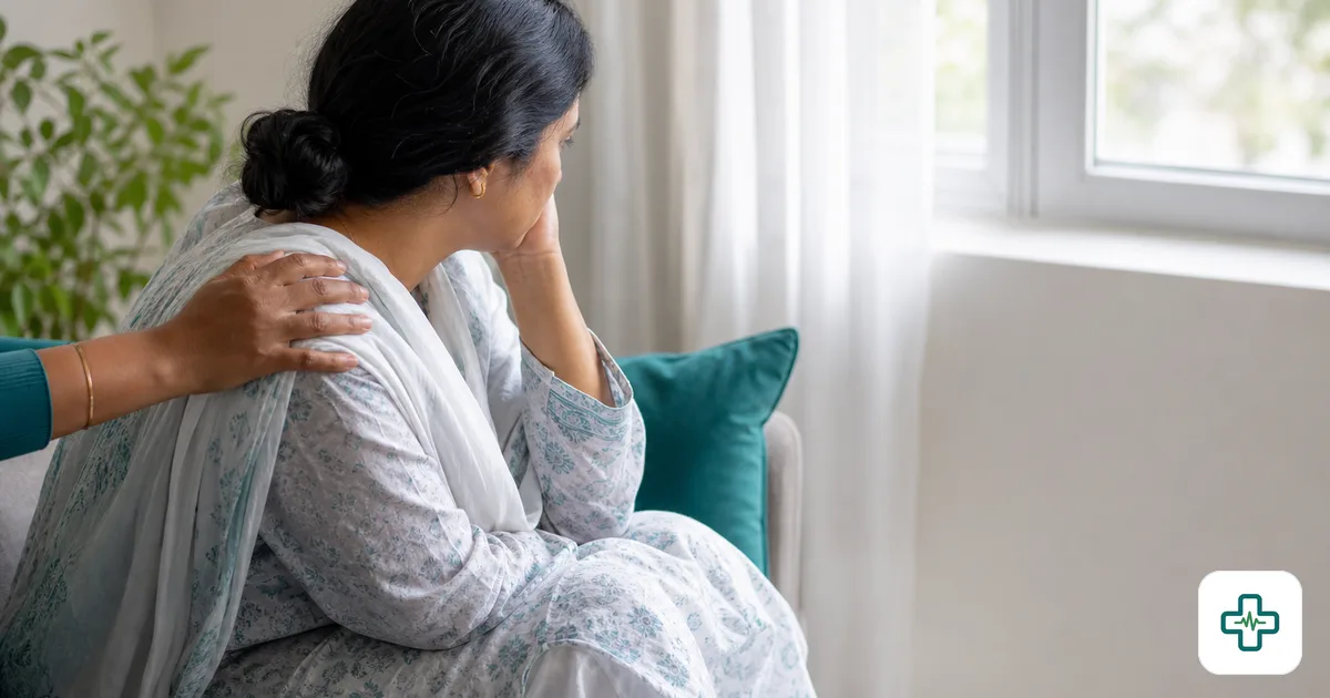 A photorealistic image of a comforting hand resting gently on the shoulder of a grieving person sitting quietly by a window in soft daylight